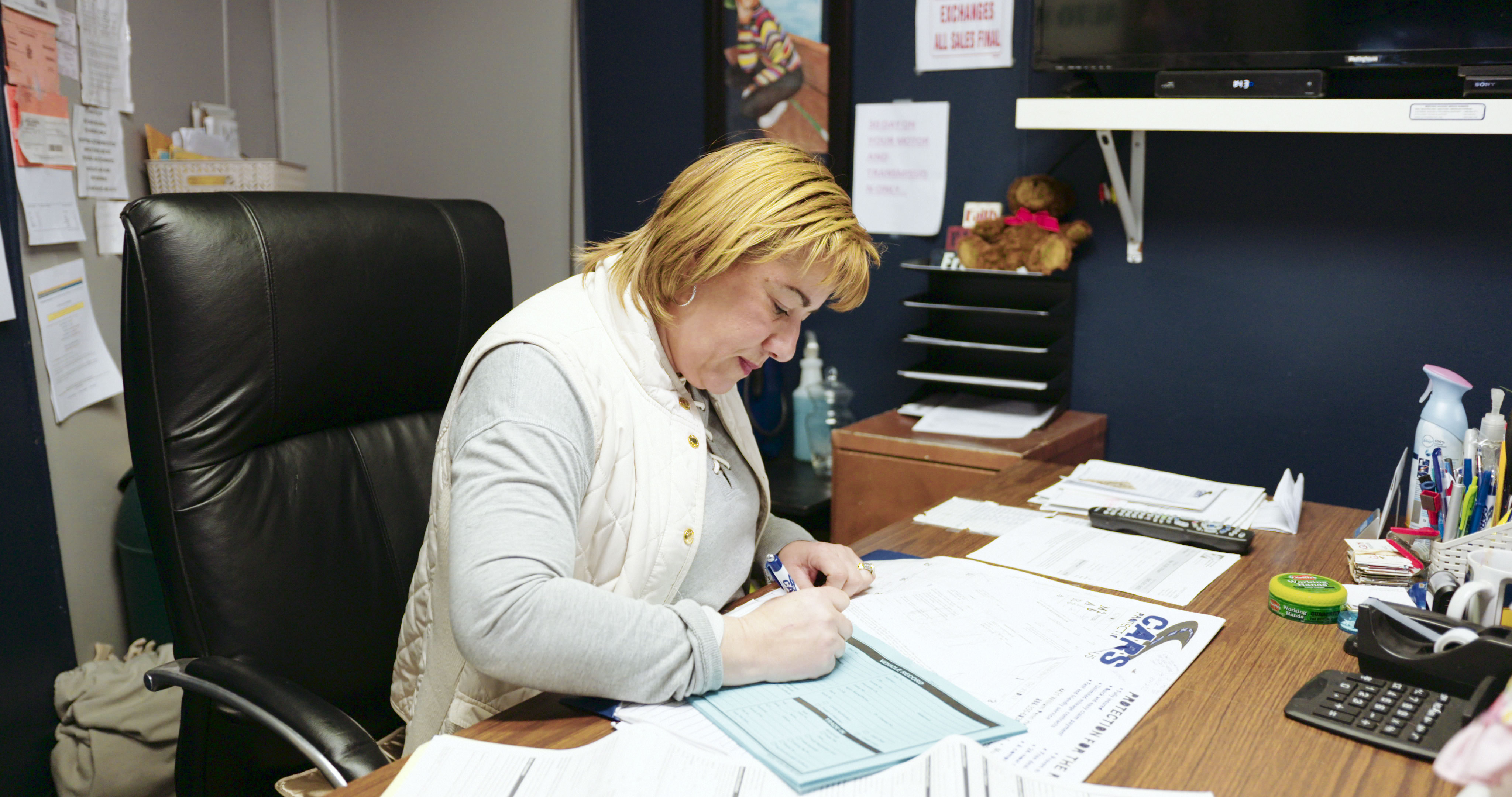 Woman working on paperwork at a desk